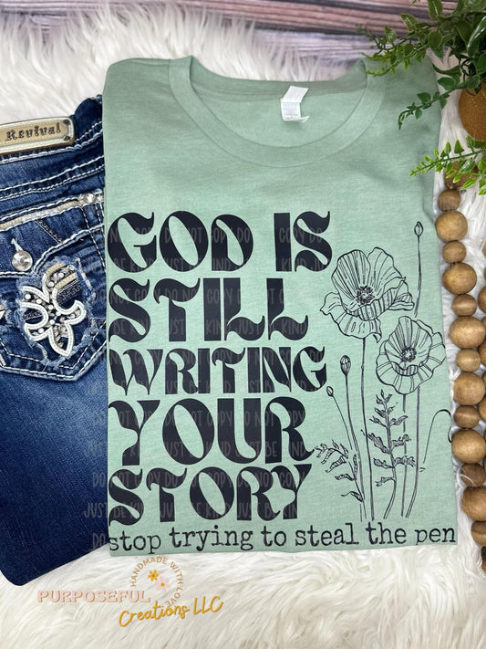God is still writing your story graphic tee